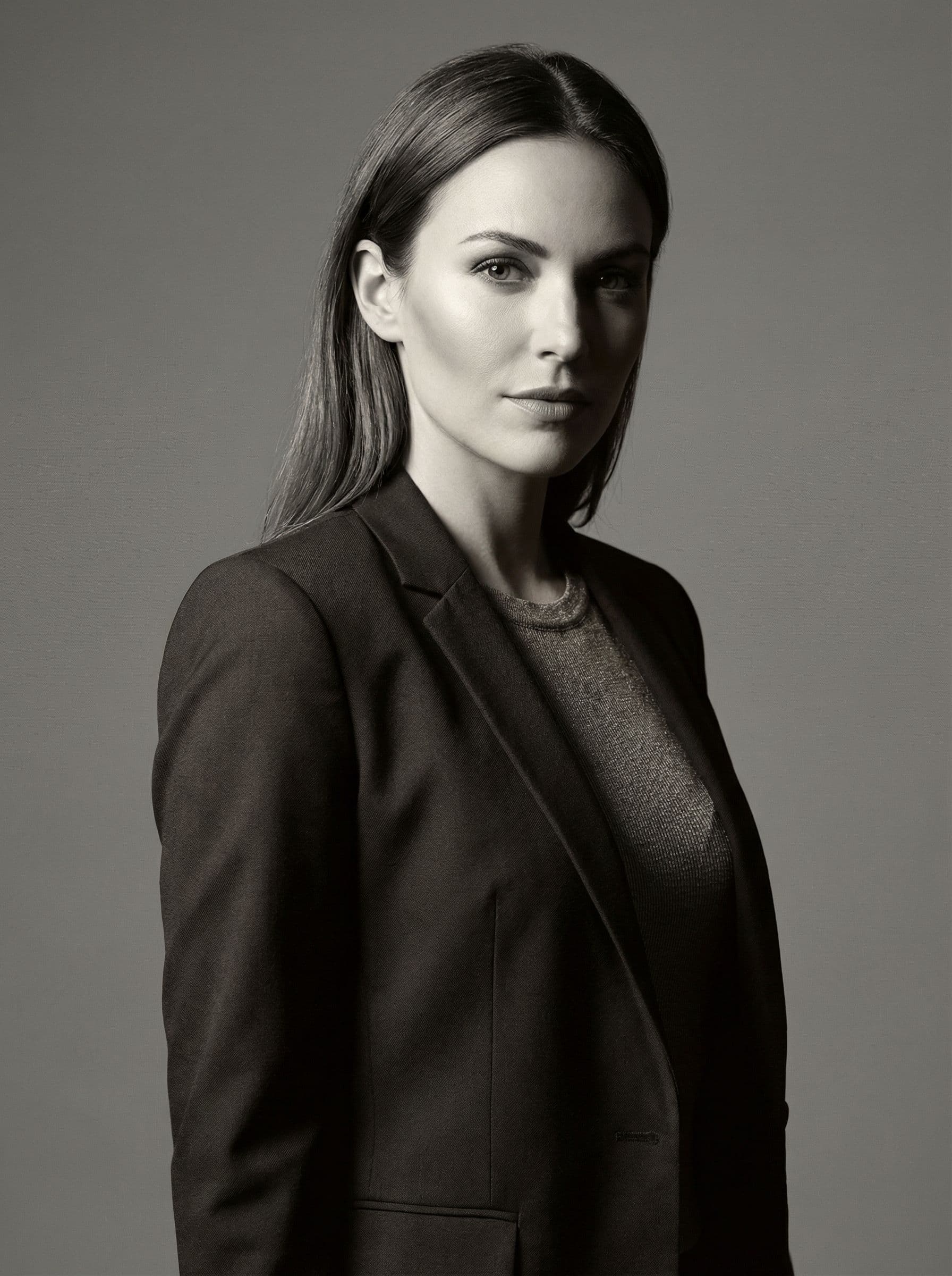 A black and white studio portrait